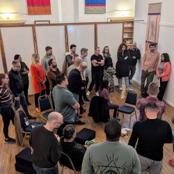 Group of people at an open space event, gathered around the agenda board