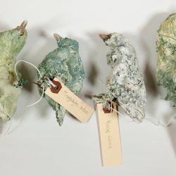 four little sculptures in the shape of birds
