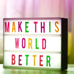 A light box, with colourful letters reading "Make this world better"