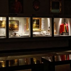 Darkened room with backlit display cases.