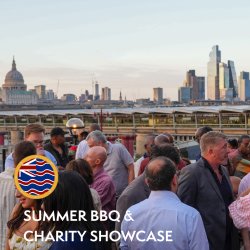 A crowd of people socialising with a view of skyscrapers in the background on a  sunny day.