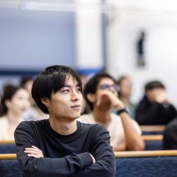Student seated in lecture theatre