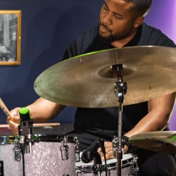 Portrait of Billy Williams playing the drums at Révéler. Photo by Peter McElhinney.