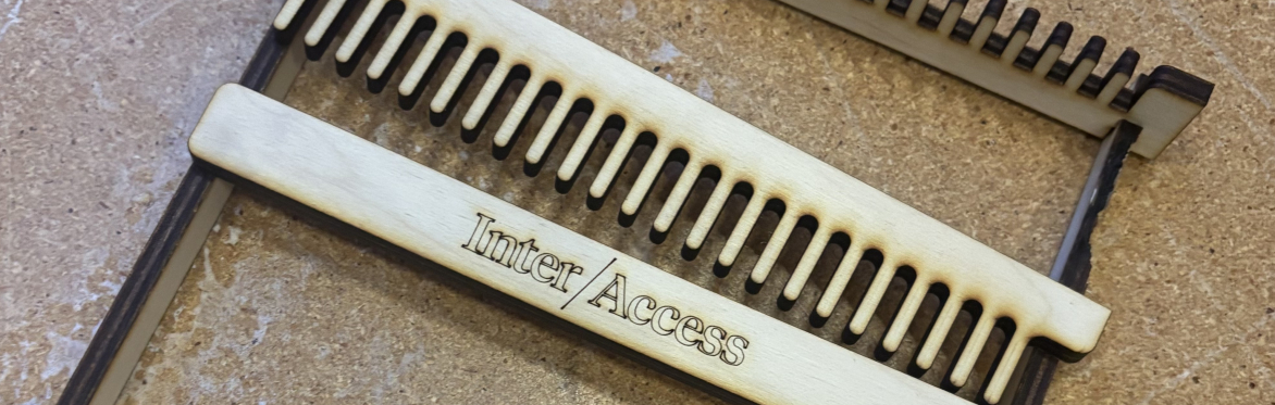 A wooden laser cut hand loom.