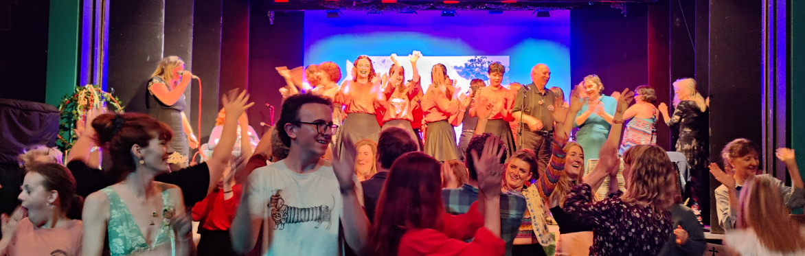 Concert goers clapping, dancing and smiling!