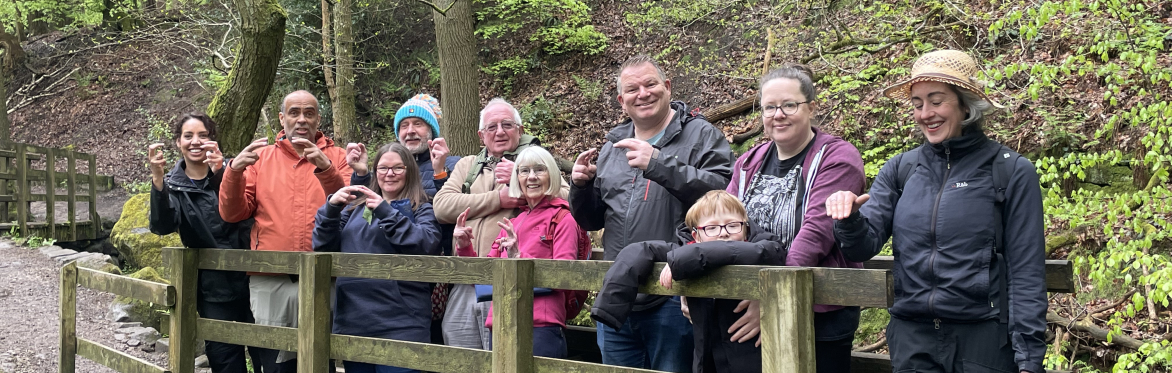 A group of people stood on a wooden footbridge