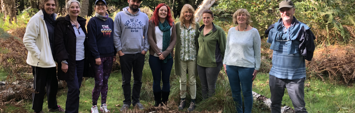Group of smiling people in the woodland