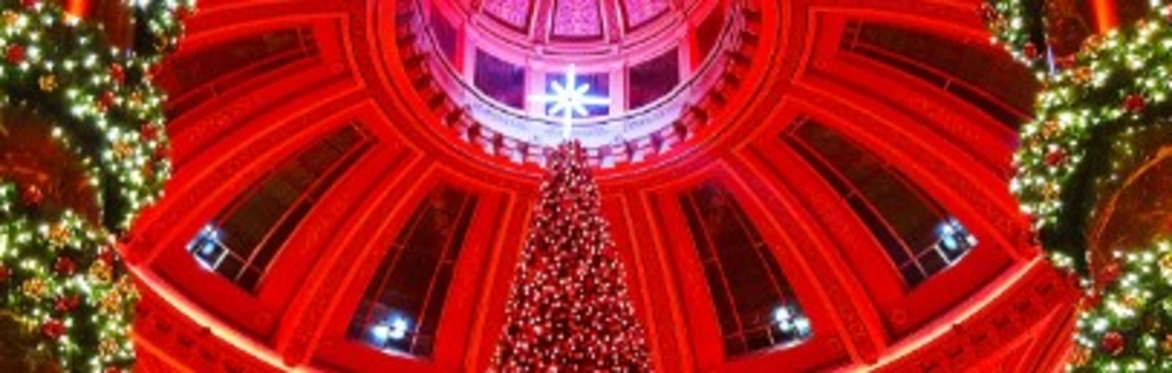 Interior of Dome in Edinburgh City Center lit in Red with Green Christmas Trees