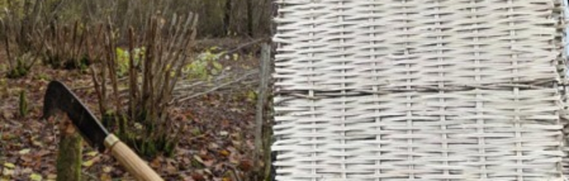 A billhook traditionally used for coppicing trees and woven hazel hurdle