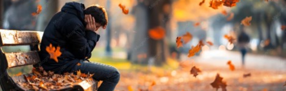 Young man sitting on park bench.