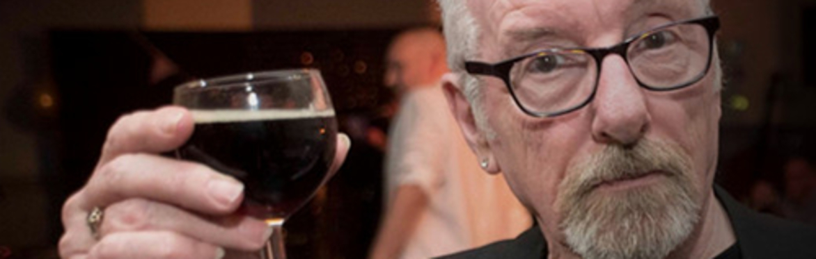 The late  David Hughes celebrating with a glass of red wine
