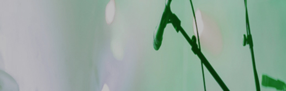 Picture of a microphone on a green background.
