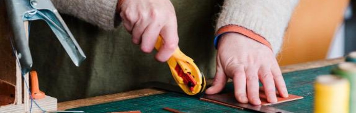 Person cutting leather to make a wallet
