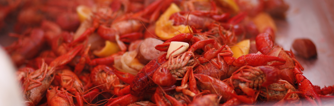Image of boiled crawfish, Louisiana style, with garlic, lemon, and sausage.