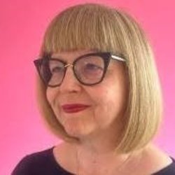 Headshot of Annabel Turpin on pink background