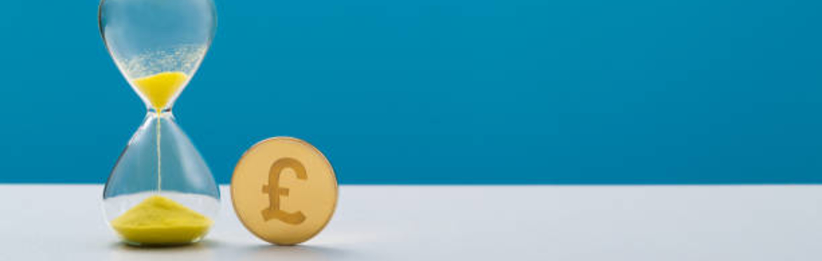 An egg timer with money next to it