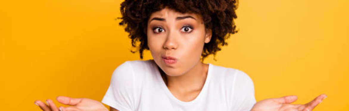 Close up of a woman with a puzzled gesture/shrugging her shoulders