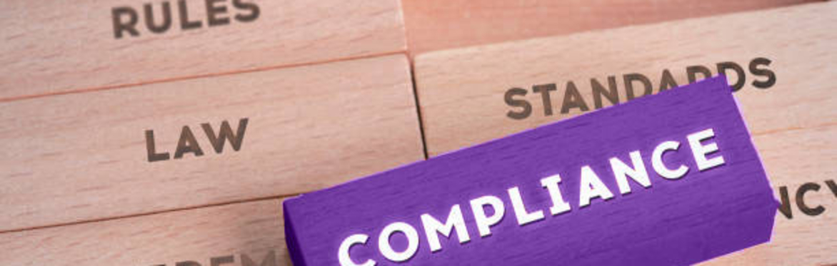 Compliance written on a purple block