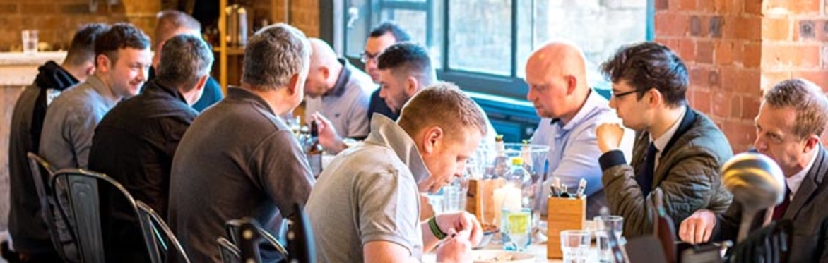 People sitting at a table eating together