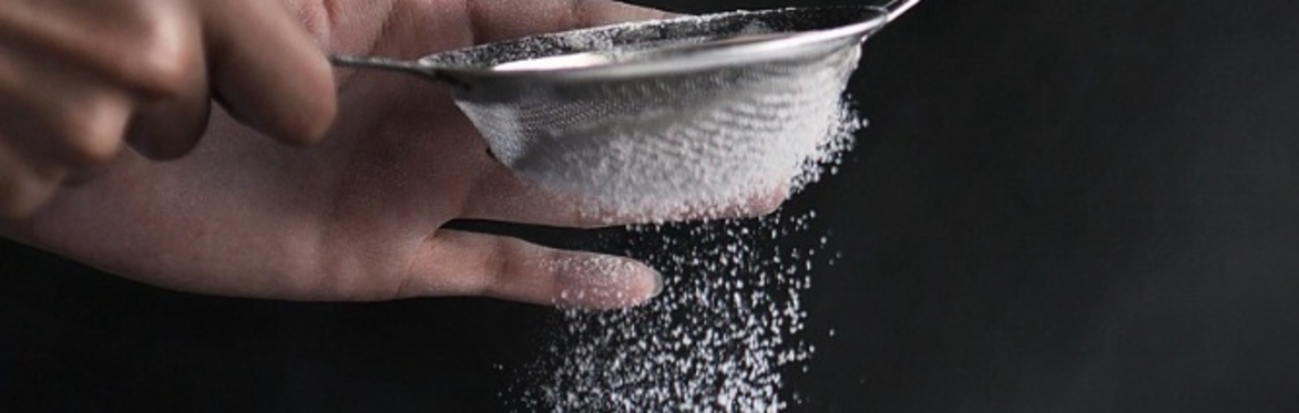 A close up of flour being sieved