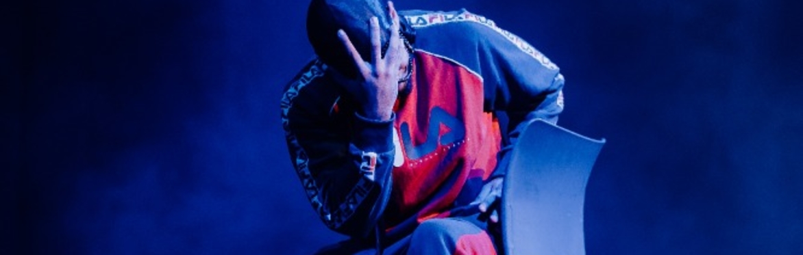A man on a chair holding his head