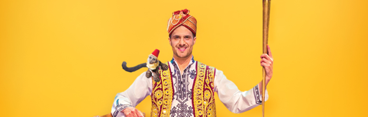 Kattam dressed in traditional garb poses with his instruments.