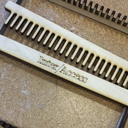A wooden laser cut hand loom.