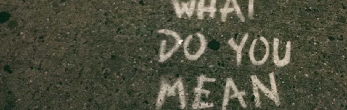 The words "What do you mean?" have been painted onto a pavement