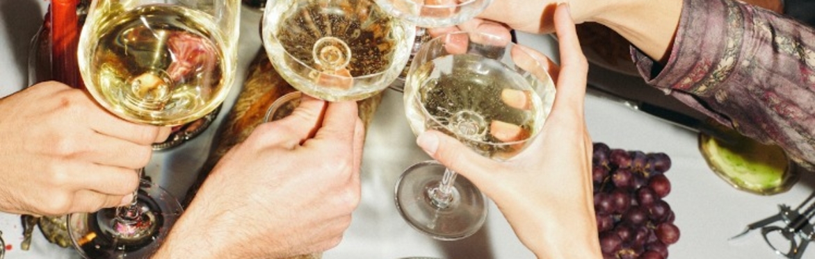 People cheers-ing glasses of wine