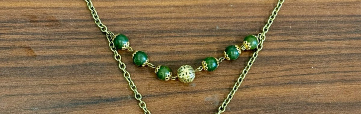 A variety of spherical gemstone beads on a string.