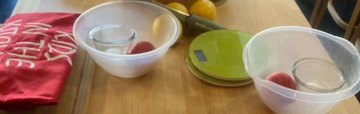 Cooking bowls, ingredients and aprons on a wooden worktop