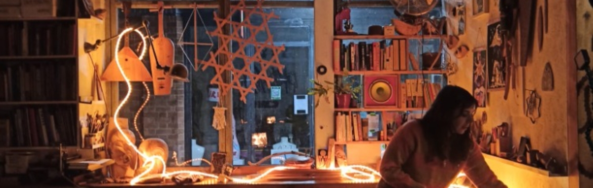 A women in a warmly lit studio space