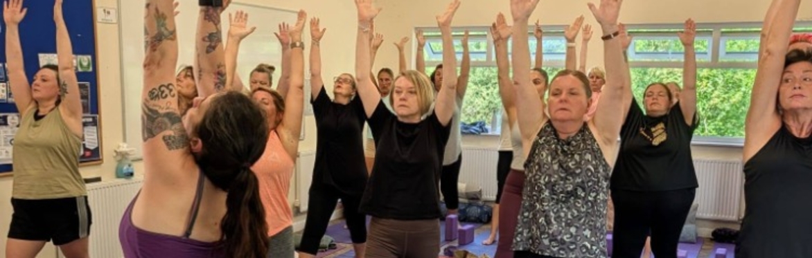 A group of women practicing yoga, enjoying the strength of warrior 1