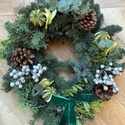 The image shows a decorated winter wreath