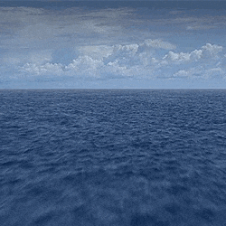 A flyover of the ocean with a cloudy sky above