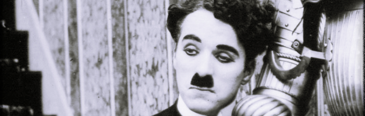 Charlie Chaplin receiving a surprise kiss.