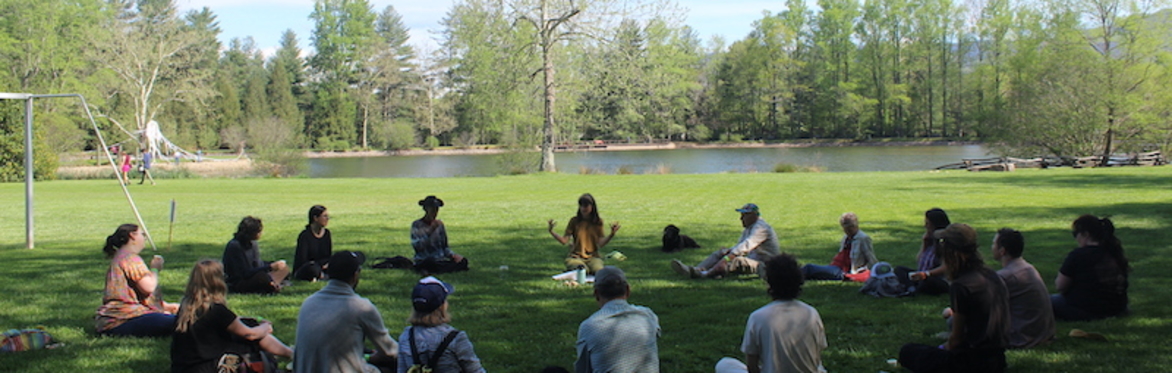 People gathered in a circle in a field