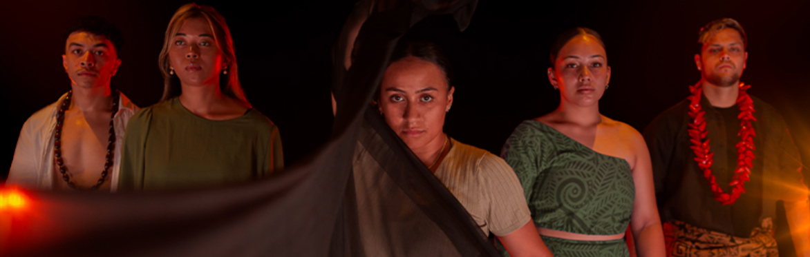 Dancers in traditional costumes performing with dramatic lighting