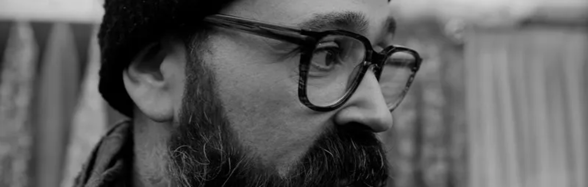 A black and white photo of Andrew Farmer, AKA FRMR