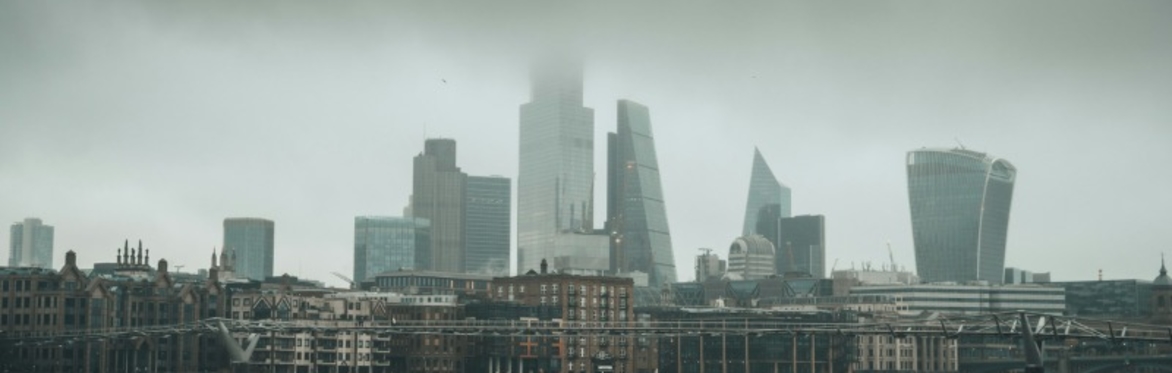 A view over the Thames looking from the southbank towards the city - you can see the walkie talkie, tower 42, the cheese grater, etc....  An ominous grey cloud hangs in the sky.