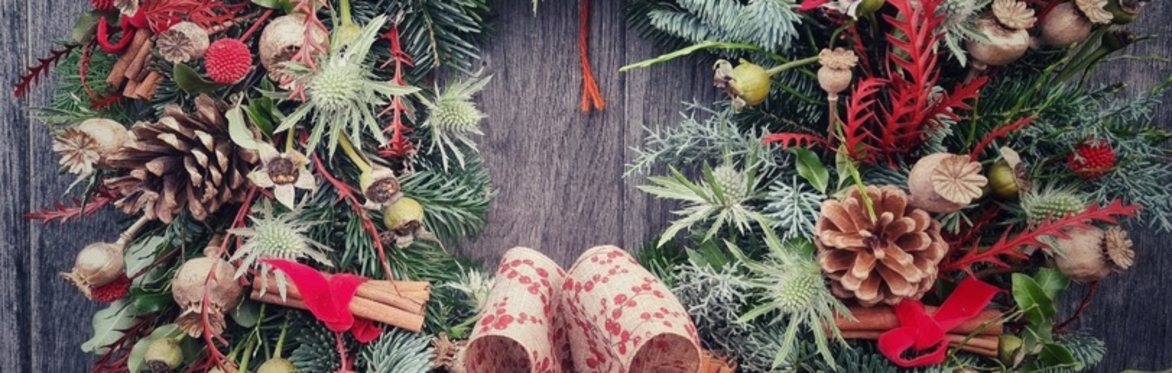 Festive Christmas wreath including red bows. pine cones & festive foliage