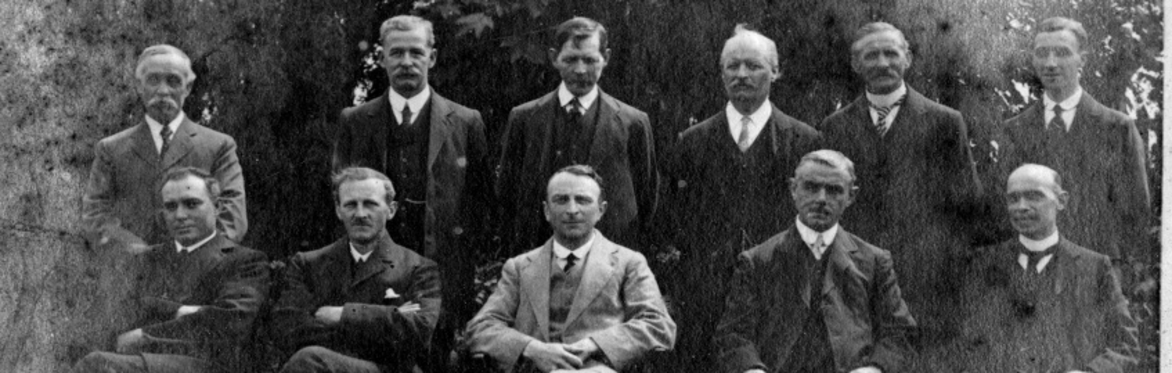 Historic black-and-white group portrait of men posed outdoors, Liverton Mines.