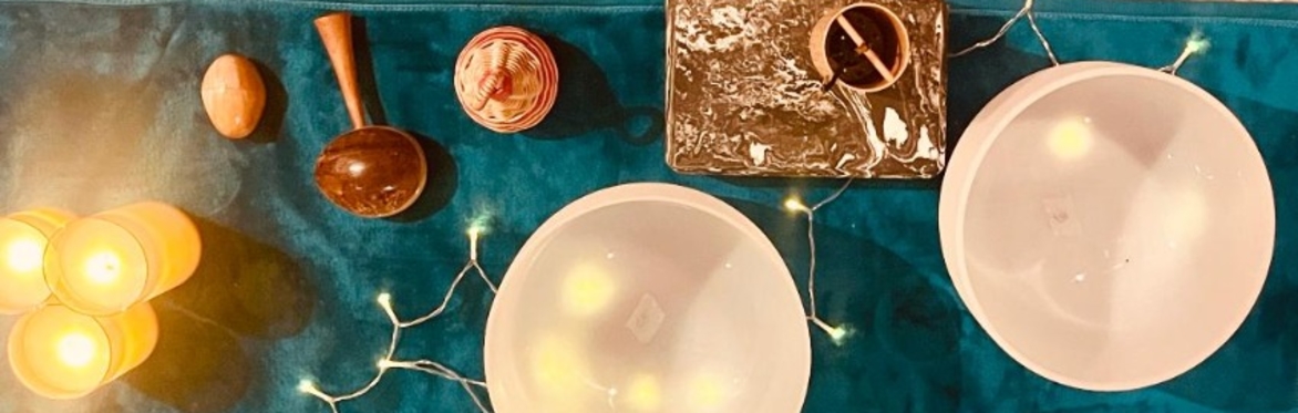 crystal bowls, shakers, fairy lights and candles on a blue blanket
