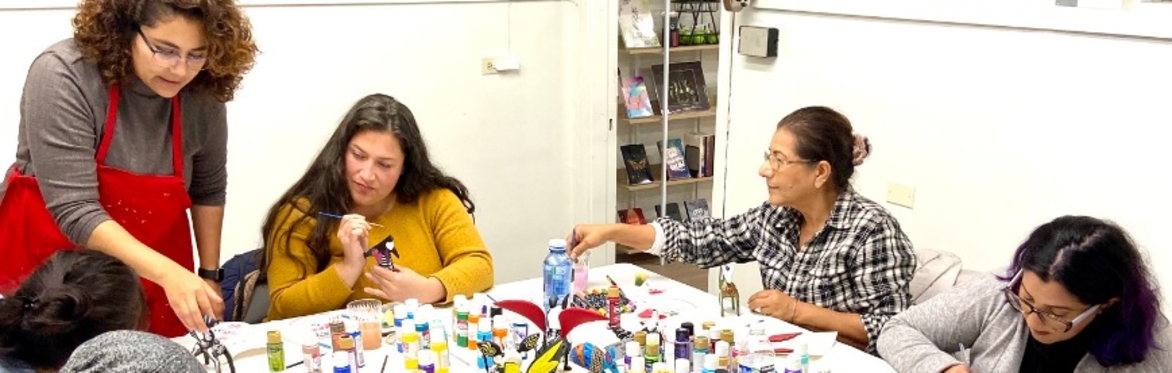 Instructor helping workshop participants with painting their Alebrijes figurines