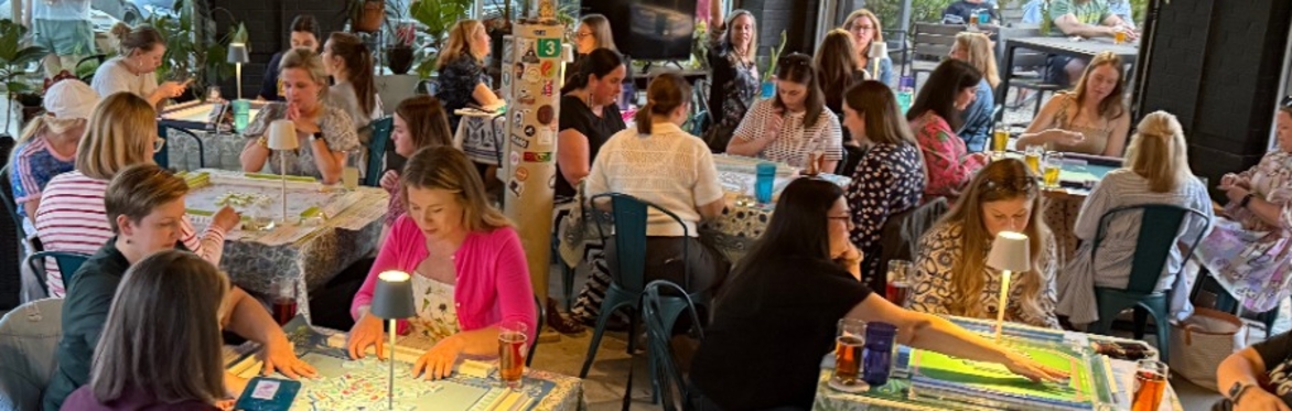 Players sitting at colorful tables playing mahjong