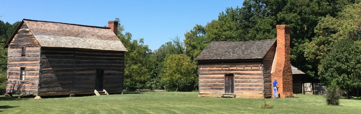 Two log cabins in a clearing