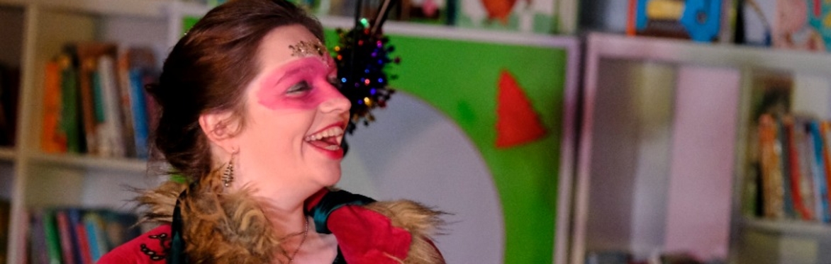 Madame Thespia in a furry coat with red eye make up and glitter