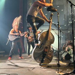 Tan and Sober gentlemen playing live, musician standing on bass cello