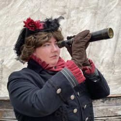 A female sea captain looking through a telescope.
