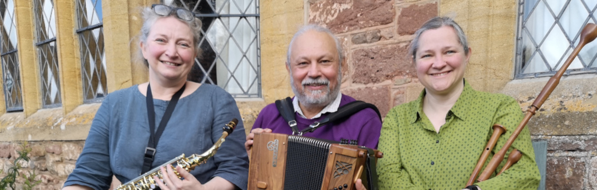 Three people holding musical instruments